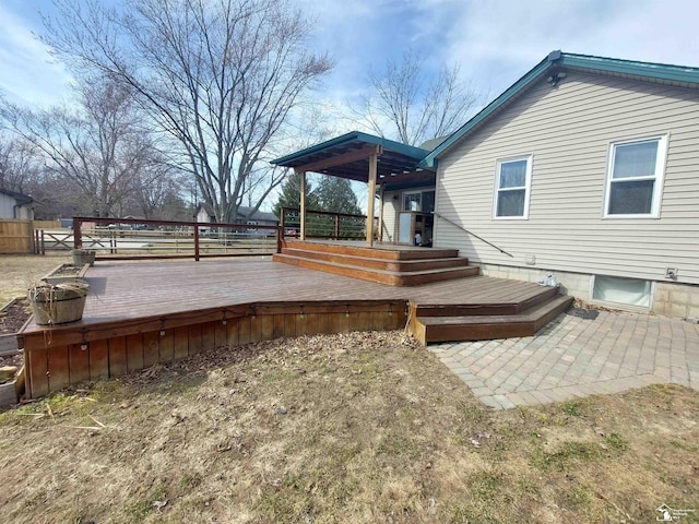 wooden deck featuring a patio and fence