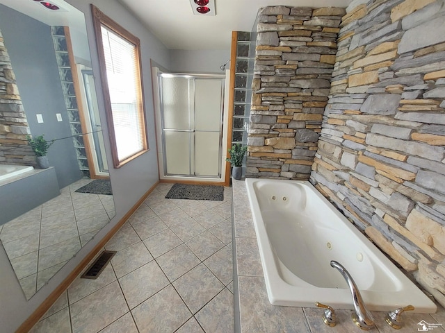 bathroom featuring tile patterned floors, visible vents, a jetted tub, and a shower stall