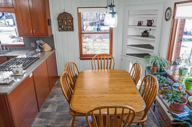 dining room with built in features and a healthy amount of sunlight