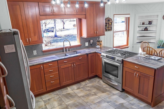 kitchen with a sink, brown cabinets, stone counters, and stainless steel appliances