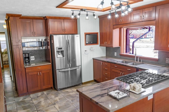 kitchen featuring a sink, brown cabinets, and stainless steel appliances