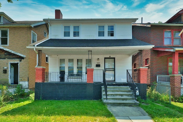 view of front of house with a porch, a chimney, a front yard, and fence