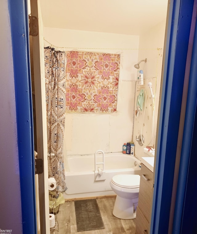 full bathroom featuring shower / bath combo with shower curtain, toilet, wood finished floors, and vanity