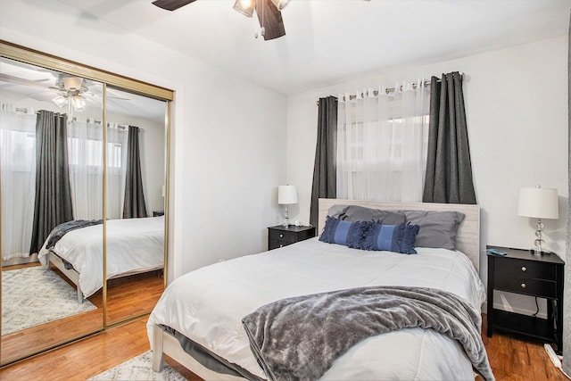 bedroom with ceiling fan, a closet, and wood finished floors