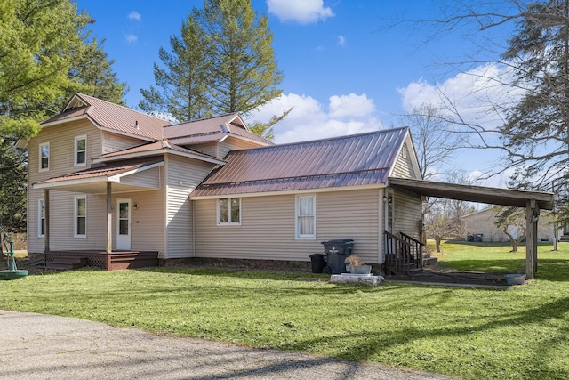 view of property exterior with metal roof and a yard