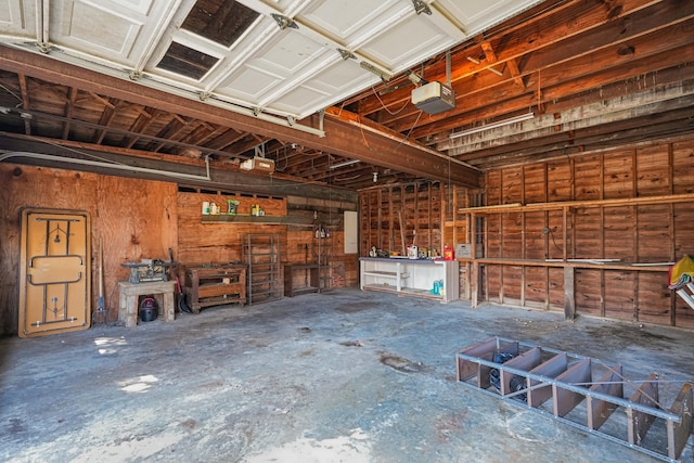 garage with a workshop area and a garage door opener