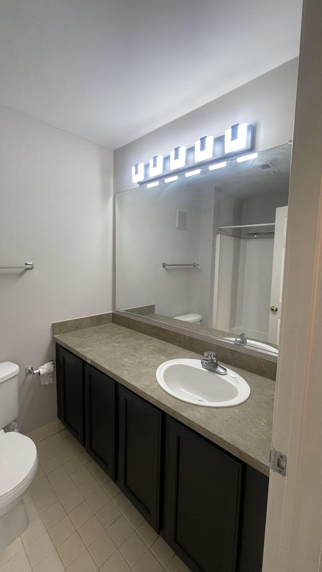 full bathroom featuring tile patterned flooring, visible vents, toilet, and vanity