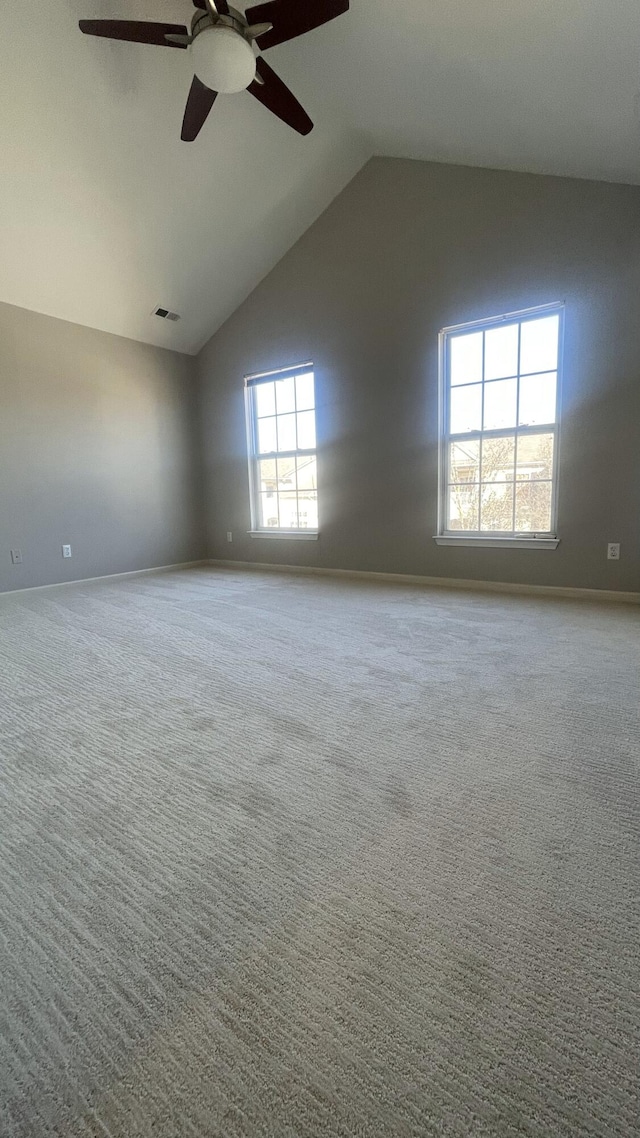 unfurnished room featuring visible vents, baseboards, carpet floors, high vaulted ceiling, and a ceiling fan