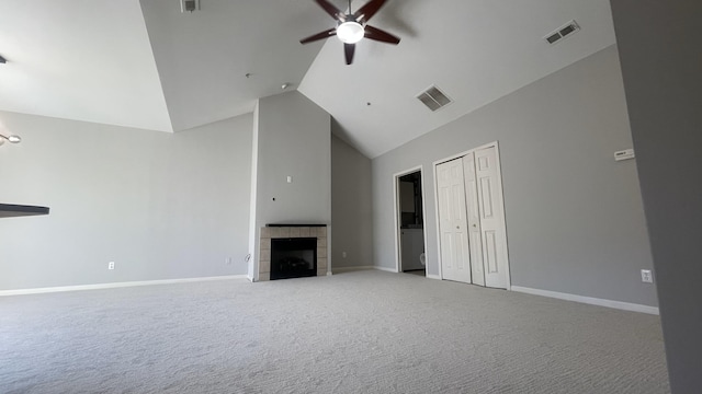 unfurnished living room with a tiled fireplace, visible vents, high vaulted ceiling, and ceiling fan