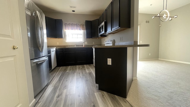 kitchen featuring light wood-type flooring, visible vents, baseboards, and appliances with stainless steel finishes