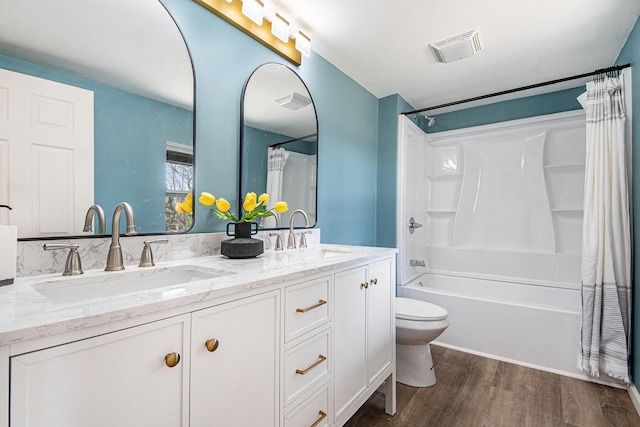 bathroom featuring shower / bathtub combination with curtain, wood finished floors, visible vents, and a sink