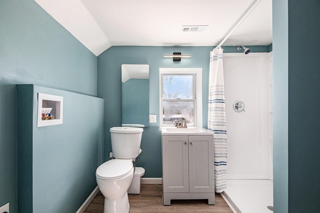 full bathroom with visible vents, wood finished floors, toilet, and a stall shower