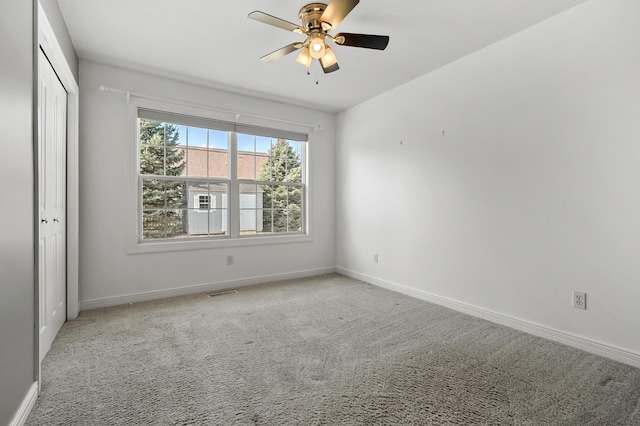 unfurnished bedroom with a ceiling fan, visible vents, baseboards, carpet floors, and a closet