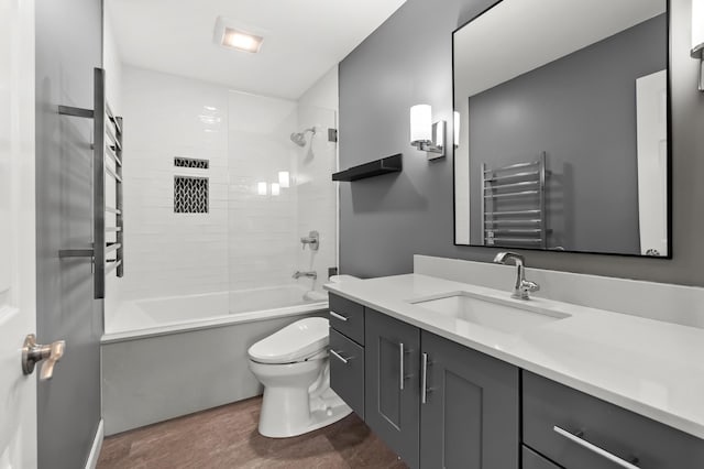 full bathroom featuring vanity, shower / bathing tub combination, radiator, and toilet