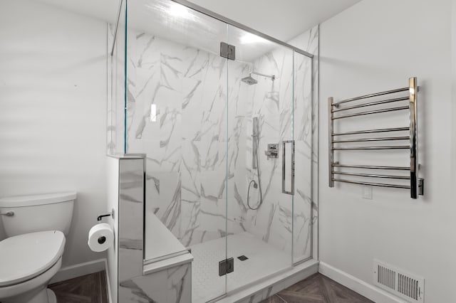 bathroom with visible vents, baseboards, toilet, and radiator heating unit