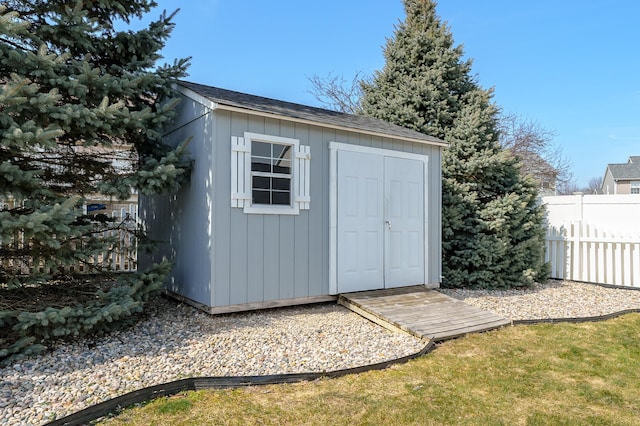 view of shed featuring fence