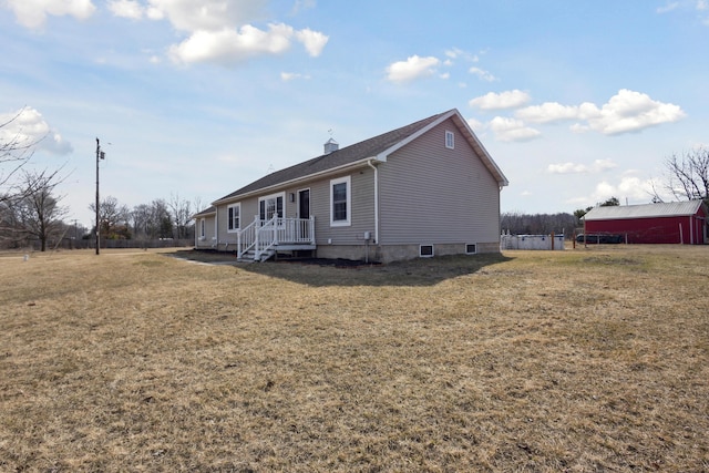 exterior space featuring a yard and a chimney