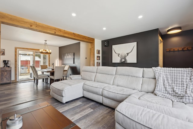 living area featuring recessed lighting, a notable chandelier, beamed ceiling, and wood finished floors