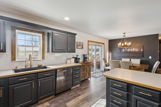 kitchen with dishwasher, an inviting chandelier, plenty of natural light, and a sink