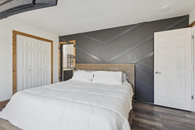 bedroom featuring a closet, visible vents, and wood finished floors