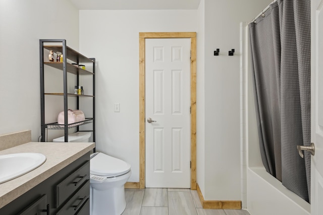 bathroom featuring toilet, shower / bath combo, and vanity