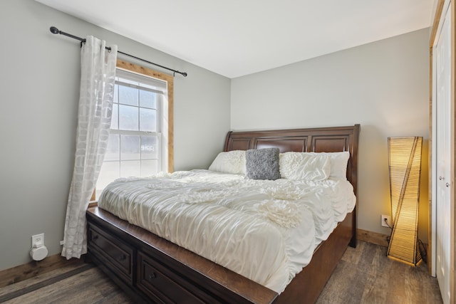 bedroom with dark wood-type flooring