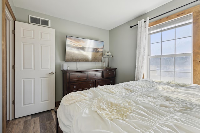 bedroom featuring visible vents and dark wood-style flooring