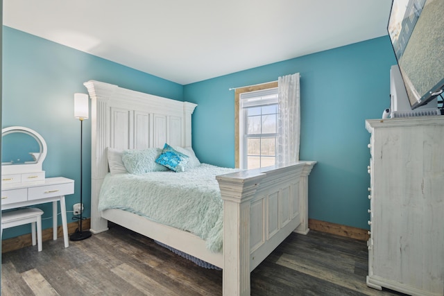 bedroom featuring baseboards and wood finished floors