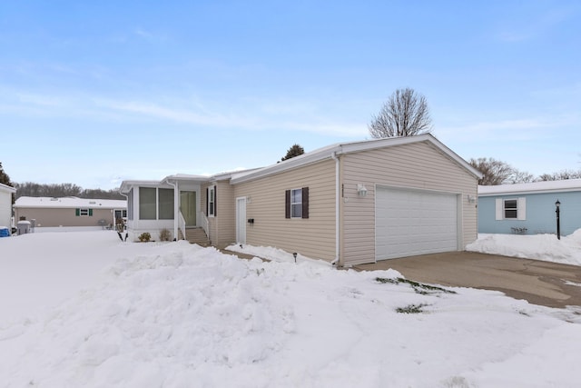 manufactured / mobile home with an attached garage and a sunroom