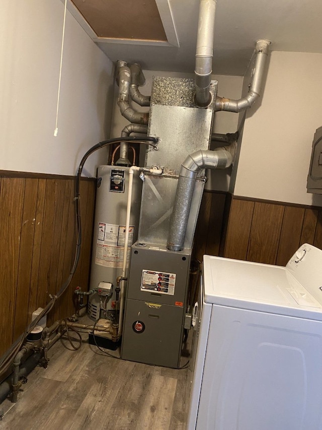 utility room featuring gas water heater and washer / dryer