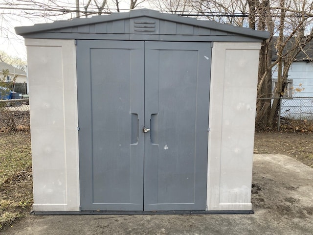 view of shed featuring fence