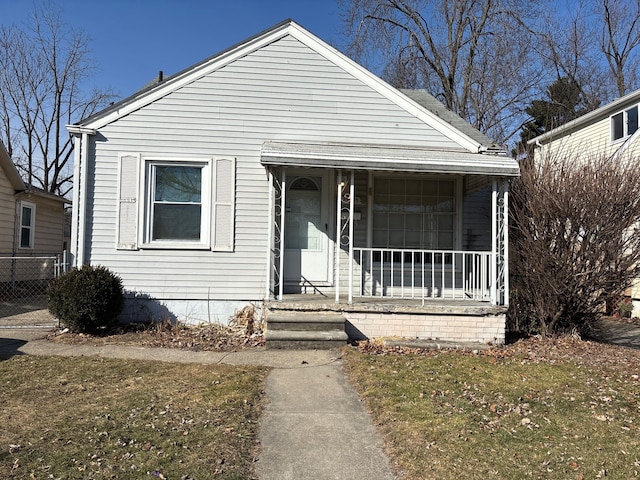 bungalow-style home with a porch and fence