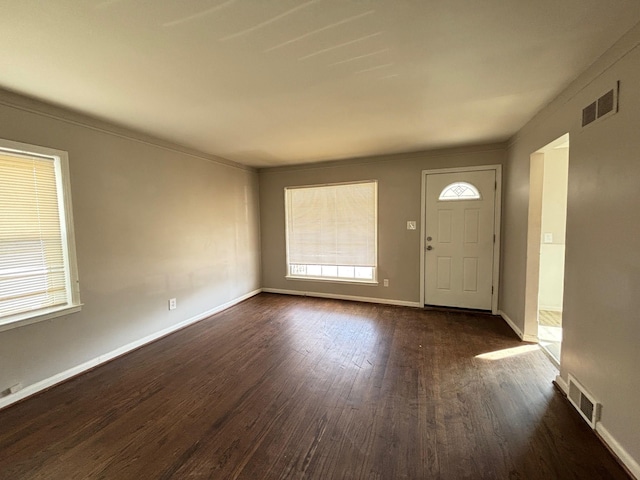 entryway featuring dark wood-type flooring, plenty of natural light, and visible vents