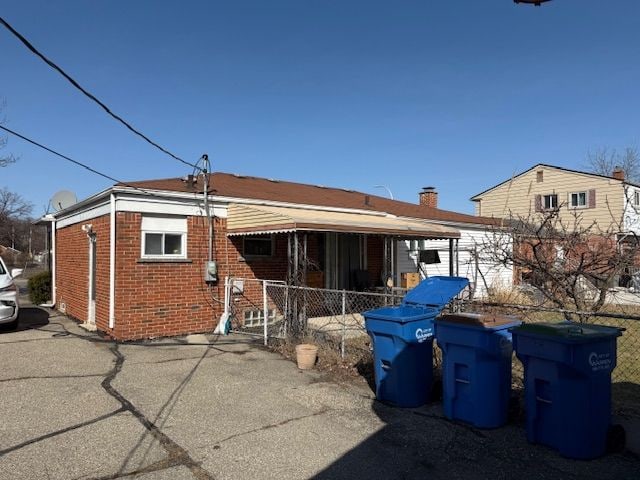 back of house with brick siding