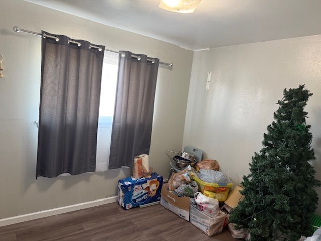 interior space featuring wood finished floors and baseboards