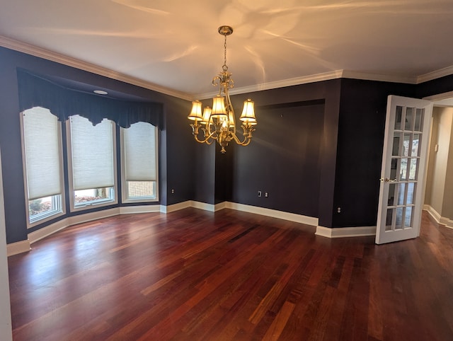 unfurnished room with baseboards, wood finished floors, a chandelier, and ornamental molding