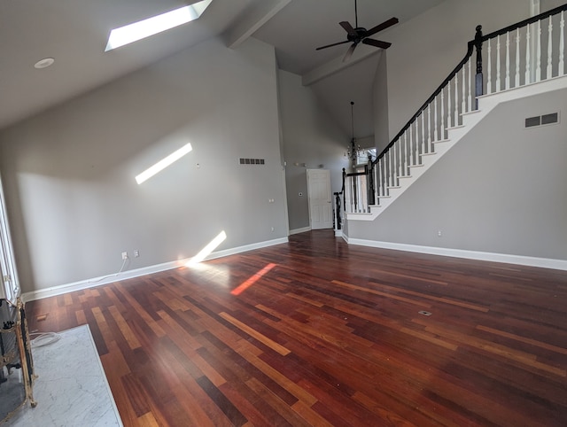 unfurnished living room with visible vents, wood finished floors, and stairway