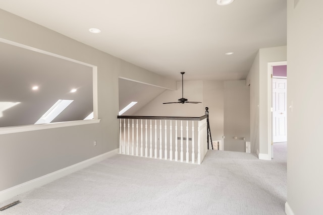 interior space with vaulted ceiling, visible vents, baseboards, and ceiling fan