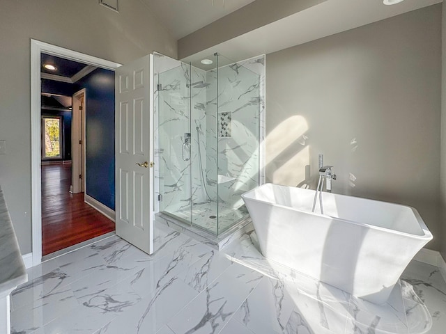 bathroom with a marble finish shower, baseboards, a freestanding bath, and marble finish floor