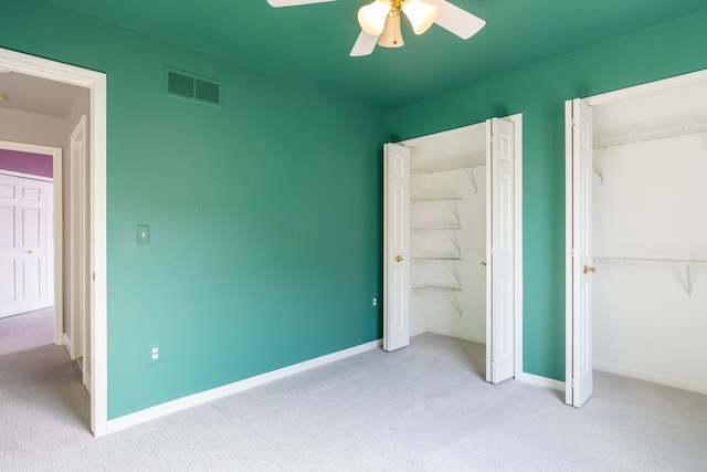 unfurnished bedroom featuring visible vents, a ceiling fan, baseboards, and carpet floors