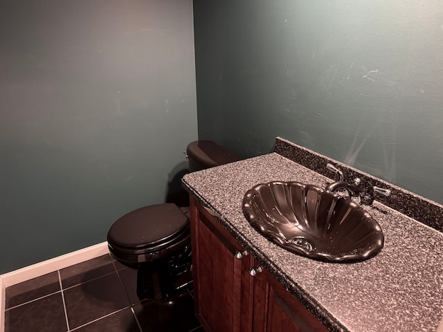 bathroom featuring tile patterned floors, toilet, vanity, and baseboards