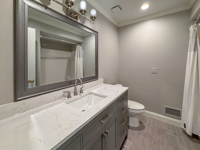 bathroom featuring visible vents, toilet, vanity, and ornamental molding