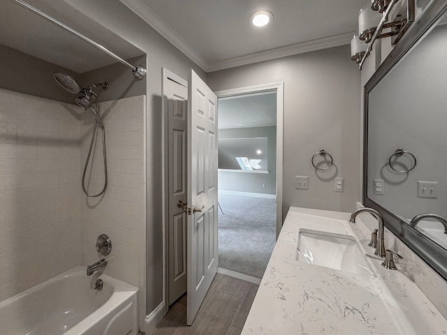 full bath with ornamental molding, wood finished floors, shower / washtub combination, baseboards, and vanity