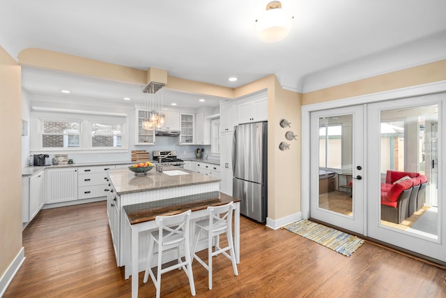 kitchen featuring a wealth of natural light, white cabinets, french doors, and appliances with stainless steel finishes