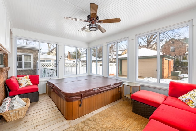 sunroom featuring ceiling fan