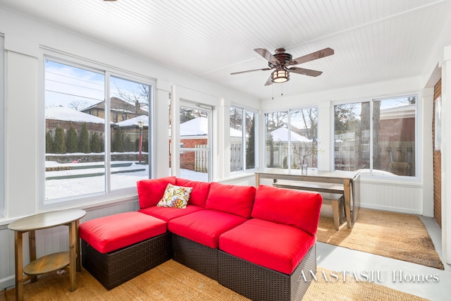 sunroom featuring a ceiling fan and a healthy amount of sunlight