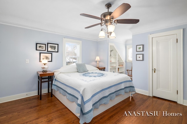 bedroom featuring ceiling fan, crown molding, baseboards, and wood finished floors