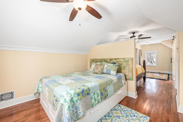 bedroom featuring visible vents, baseboards, lofted ceiling, and wood-type flooring