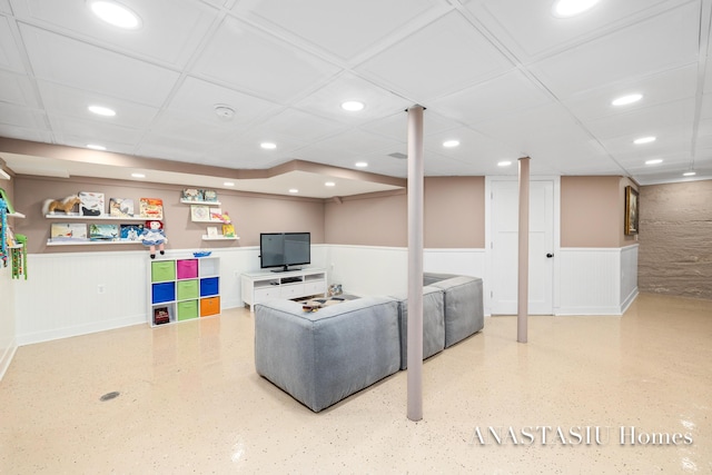 living room with recessed lighting, a wainscoted wall, and a paneled ceiling