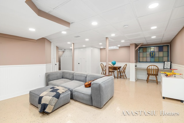 living area with stairway, a paneled ceiling, recessed lighting, and wainscoting